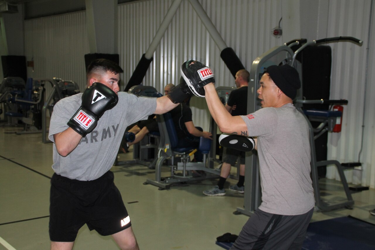 Army Sgt. Marcos Benitez, right, an M1A2 Abrams tank gunner with 1st Battalion, 8th Infantry Regiment, spars with Sgt. 1st Class Joel Vallete, the battalion’s signal section chief, at a gymnasium at Mihail Kogalniceanu Air Base, Romania, March 8, 2017. Army photo by Spc. Matthew Searcy