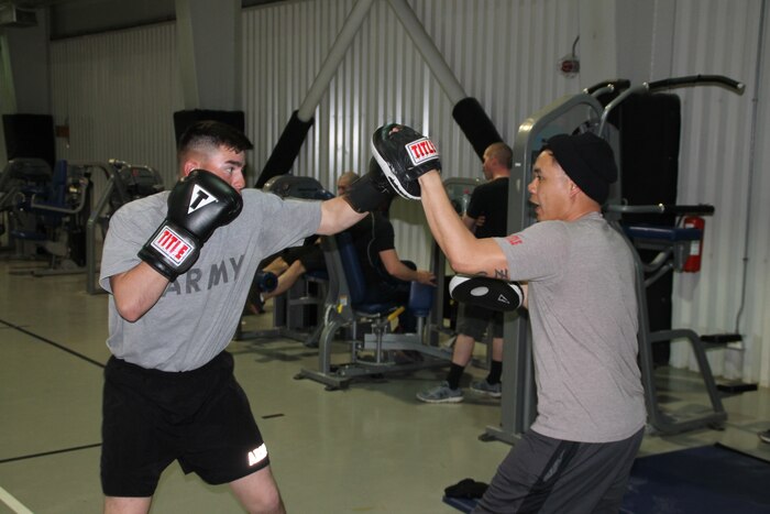 Army Sgt. Marcos Benitez, right, an M1A2 Abrams tank gunner with 1st Battalion, 8th Infantry Regiment, spars with Sgt. 1st Class Joel Vallete, the battalion’s signal section chief, at a gymnasium at Mihail Kogalniceanu Air Base, Romania, March 8, 2017. Army photo by Spc. Matthew Searcy