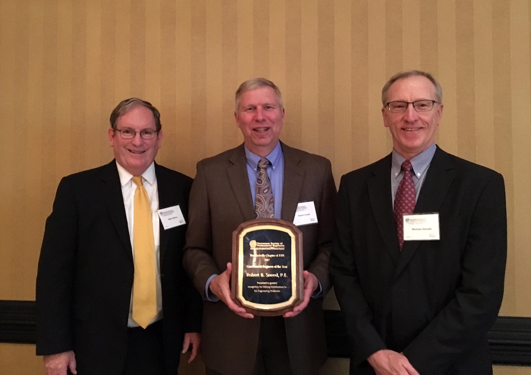 Bob Sneed (Center), retired U.S. Army Corps of Engineers Nashville District Water Management Section chief, poses with Mike Wilson (Left), Nashville District deputy for Programs and Project Management, and Mike Zoccola, retired Nashville District Civil Design Branch chief, after being named Government Engineer of the Year by the Tennessee Society of Professional Engineers at a banquet Feb. 24, 2017 at the Renaissance Hotel in Nashville, Tenn. Wilson and Zoccola are both former recipients of the award.