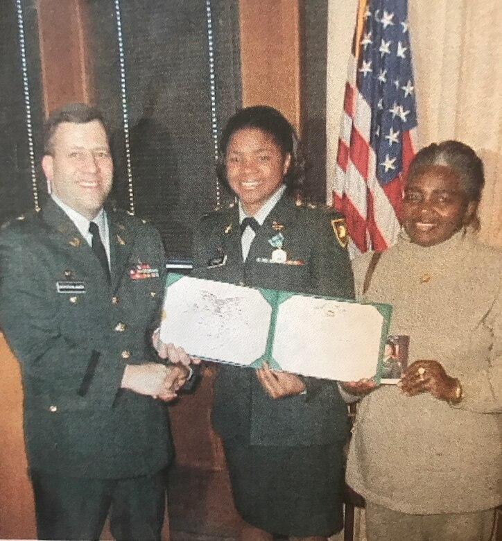 U.S. Army Lt. Col. James Gerstenlauer presents Capt. Claudia Lynch and her mother, Norma Lynch, with her separation papers at West Point, N.Y., Oct. 2002. Lynch returned to Ft. Eustis as a civilian in 2007 as an administrative law attorney. (Courtesy Photo)