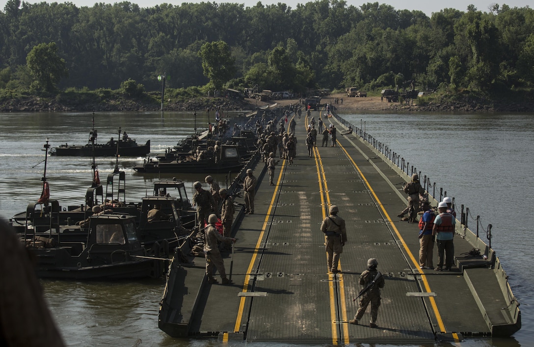 Marines with Bridge Company, 8th Engineer Support Battalion, Bridge Co. Bravo, 6th ESB and U.S. Army soldiers with 814th Multi-Roll Bridge Co. begin allowing vehicles to cross the continuous span bridge during Exercise River Assault on Fort Chaffee, July 19, 2016. The Marines spent two weeks operating Mk3 bridge erection boats and practicing connecting IRBs in preparation for the final exercise, which was a continuous IRB spanned across the Arkansas River. (U.S. Marine Corps photo by Cpl. Justin T. Updegraff)