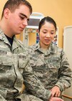 Capt. (Dr.) Thanh Thao Le, a family medicine physician assigned to the 66th Medical Squadron, checks the pulse of Senior Airman Chad A. Stricker, Jr., at the Hanscom Air Force Base, Mass., clinic March 24. Le moved from Vietnam to the United States with her family when she was 12-years old through a U.S. government program for former South Vietnamese officials. (U.S. Air Force photo by Walter Santos)