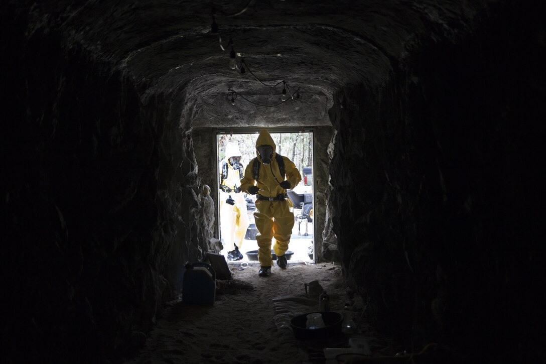 U.S. service members attending Naval School Explosive Ordnance Disposal (NAVSCOLEOD) conduct chemical biological handling of hazardous materials and decontamination during a simulated cave training exercise at Eglin Air Force Base, Fla., March 8, 2017. The purpose of NAVSCOLEOD is to train technicians in basic, as well as advanced, courses to perform various duties that include locating, identifying, rendering safe, and disposing of bombs and other hazardous materials. (U.S. Marine Corps photo by Cpl. Laura Mercado)