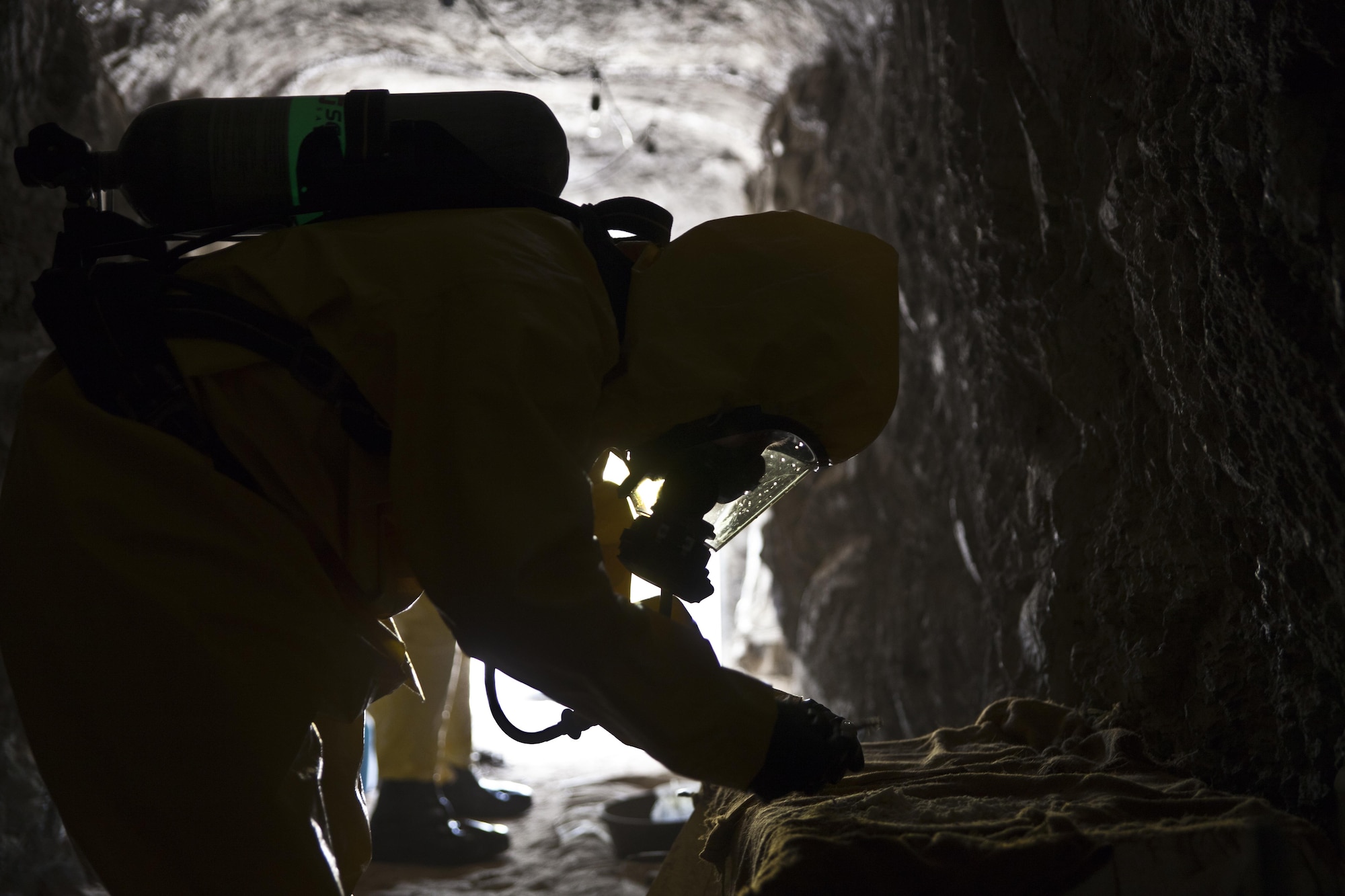 U.S. service members attending Naval School Explosive Ordnance Disposal (NAVSCOLEOD) conduct chemical biological handling of hazardous materials and decontamination during a simulated cave training exercise at Eglin Air Force Base, Fla., March 8, 2017. The purpose of NAVSCOLEOD is to train technicians in basic, as well as advanced, courses to perform various duties that include locating, identifying, rendering safe, and disposing of bombs and other hazardous materials. (U.S. Marine Corps photo by Cpl. Laura Mercado)