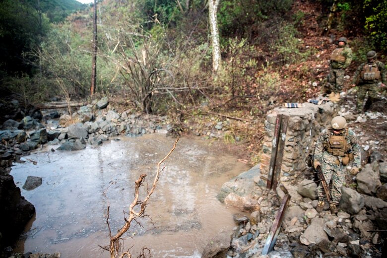 U.S. Marines with 7th Engineer Support Battalion, 1st Marine Logistics Group, clean up the aftermath of the demolition of one of the dams at Cleveland National Forest in Silverado, Calif., while placing C4 on the next part of the dam on March 22, 2017. There will be two more iterations of this training over the next two years, demolishing 10 dams every year until all 30 dams have been removed. (U.S. Marine Corps photo by Lance Cpl. Adam Dublinske)