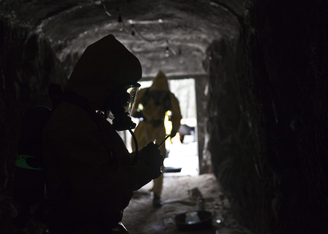 U.S. service members attending Naval School Explosive Ordnance Disposal (NAVSCOLEOD) conduct chemical biological handling of hazardous materials and decontamination during a simulated cave training exercise at Eglin Air Force Base, Fla., March 8, 2017. The purpose of NAVSCOLEOD is to train technicians in basic, as well as advanced, courses to perform various duties that include locating, identifying, rendering safe, and disposing of bombs and other hazardous materials. (U.S. Marine Corps photo by Cpl. Laura Mercado)