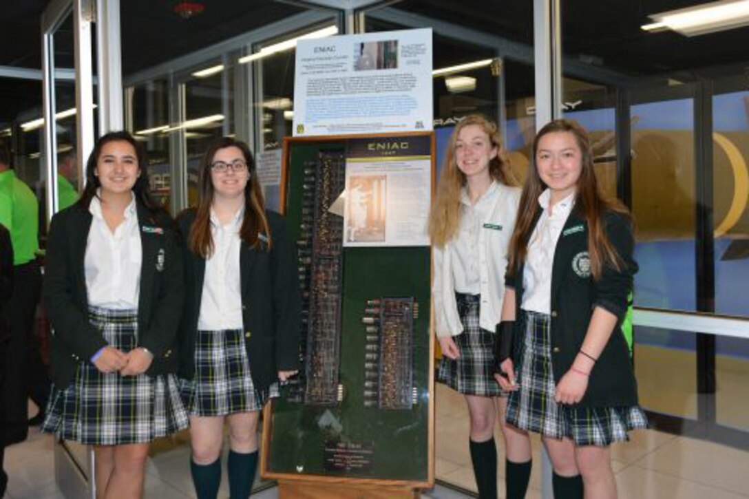 Four students from the Catholic High School of Baltimore stand in front of what remains of the Electronic Numerical Integrator And Calculator at the U.S. Army Research Laboratory’s DoD Supercomputing Research Center. Photo by Jim Nelson,