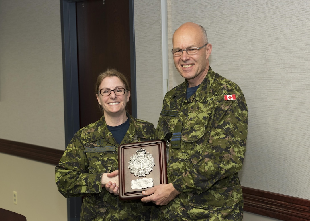 MAJ Mike Adamczyk, command chaplain, receives a retirement plague from the Canadian Armed Forces Chaplain Branch. The NORAD and USNORTHCOM Office of the Command Chaplain at held a religious affairs workshop titled  "Embracing Complexity-Navigating Uncertainty" March 23, 2017. The three-day event focused on strengthening relationships and interoperability with military mission partners. Attendees included the National Guard, National Guard Bureau, the Royal Bahamas Defence Force Command Chaplain, Canadian Armed Forces Chaplain General Representative, NORAD & USNORTHCOM Region, and Component and Subordinate Command Chaplains.
