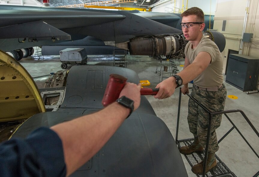 Airman 1st Class Zachary Campfield, 5th Maintenance Squadron crew chief, reaches for a hammer at Minot Air Force Base, N.D., March 20, 2017. The crew chiefs perform daily aircraft maintenance, to include diagnosing malfunctions and replacing damaged components. (U.S. Air Force photo/Airman 1st Class Jonathan McElderry)