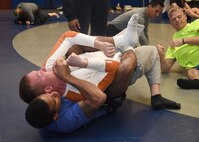 SCHRIEVER AIR FORCE BASE, Colo.— Quintin Rice, initiates a choke hold submission on Cameron Crabtree, during a combative class at Schriever Air Force Base, Colorado, Wednesday, March 29, 2017. The class is conducted every Wednesday 6 - 7 a.m. in the fitness center. (U.S. Air Force photo/Staff Sgt. Matthew Coleman-Foster)