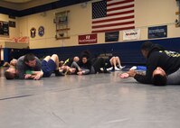 SCHRIEVER AIR FORCE BASE, Colo. — combative class participants receive instruction on side mount positioning, during their first combative class at Schriever Air Force Base, Colorado, Wednesday, March 29, 2017. Attendees had varying levels of experience, from beginners to individuals with wrestling backgrounds. (U.S. Air Force photo/Staff Sgt. Matthew Coleman-Foster)