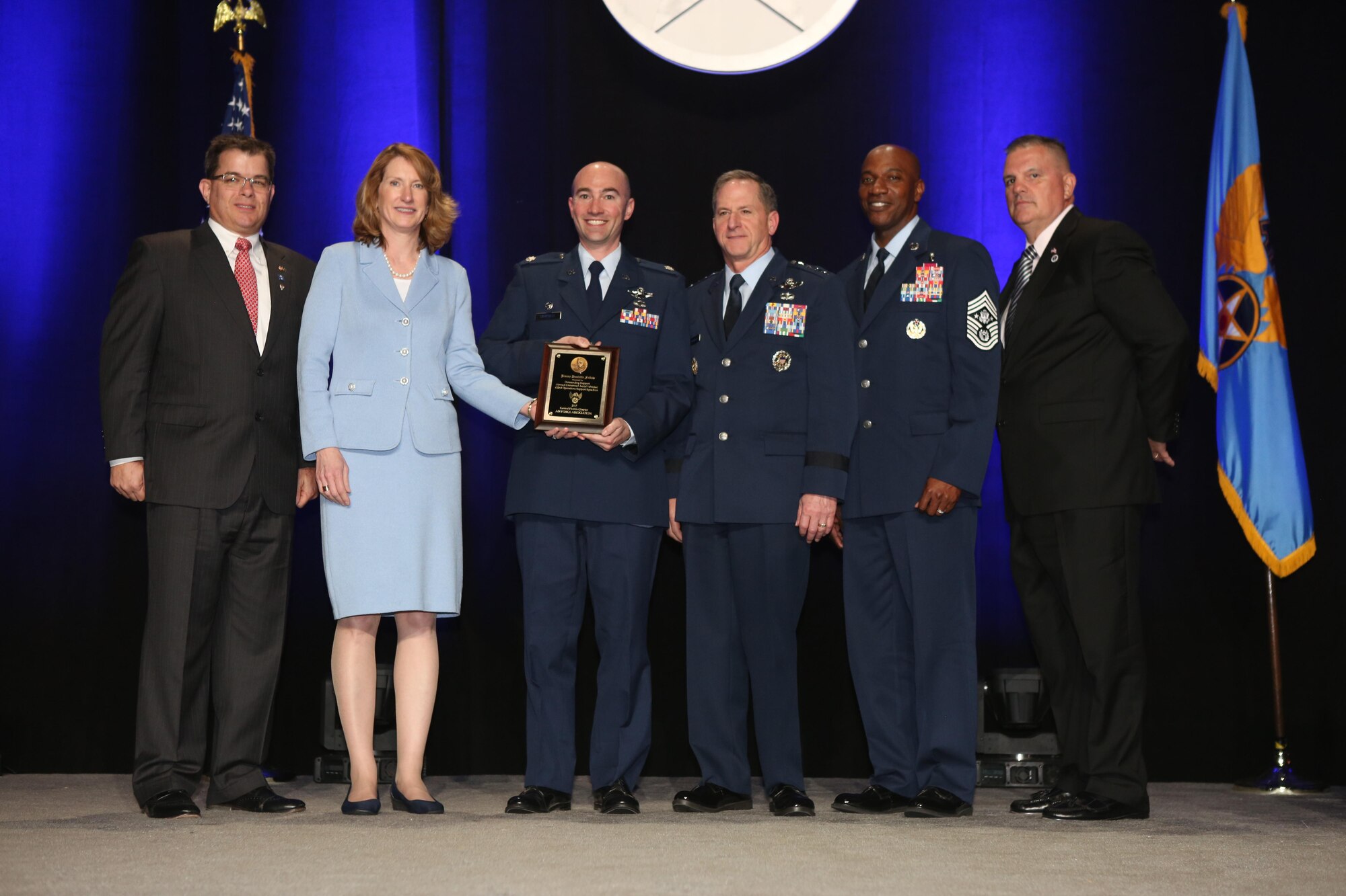 Lt. Col. Scott, former 432nd Operations Support Squadron commander, accepts the inaugural Jimmy Doolittle Educational Fellow for Outstanding Support to Armed UAVs March 2, 2017, at the Martin H. Harris Chapter of the Air Force Association Air Force Gala banquet in Orlando, Florida. Acting Secretary of the Air Force, Lisa Disbrow, presented the award alongside, from left, Air Force Gala Chairman Michael Liquori, Chief of Staff of the Air Force Gen. David Goldfein, Chief Master Sgt. of the Air Force Kaleth Wright and Martin H. Harris Chapter President Gary Lehmann. (Courtesy Photo)