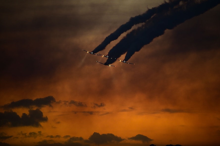 The AeroShell aerobatic team performs a twilight show during the Wings Over Golden Isles Air Show in Brunswick, Ga., March 24, 2017. The team, which has been performing for more than 27 years, performs with four North American T-6 Texans. (U.S. Air Force photo/Senior Airman Kimberly Nagle)