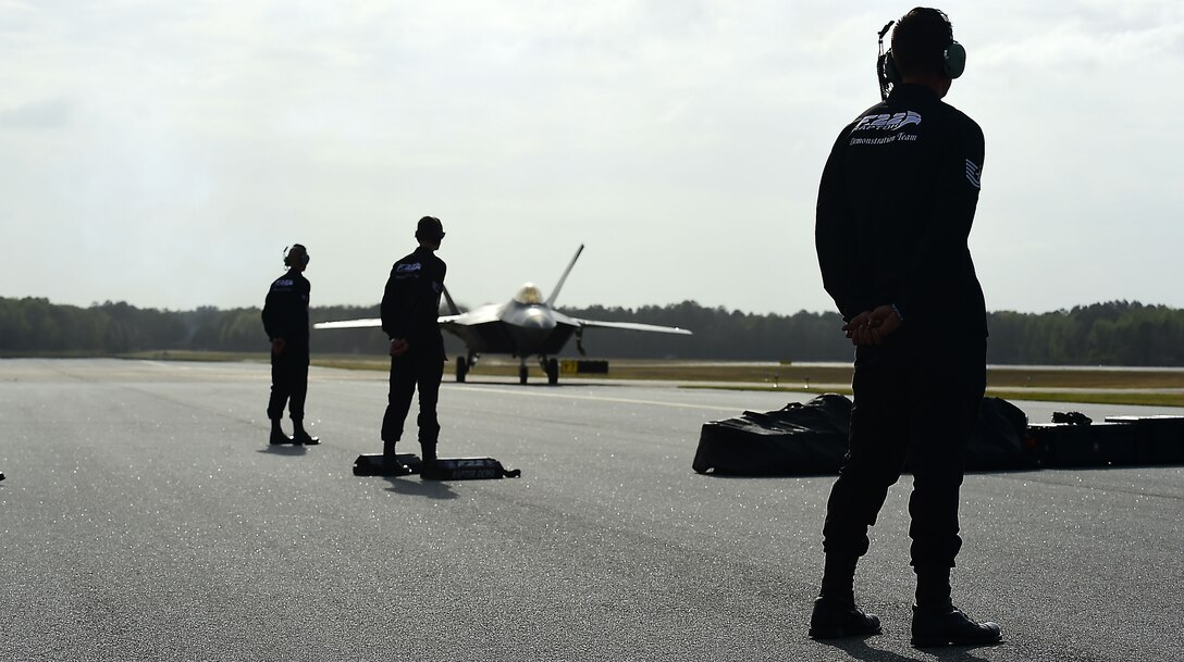 Members of the F-22 Raptor Demonstration Team wait for the arrival of the jets during the Wings Over Golden Isles Air Show in Brunswick, Ga., March 23, 2017. The F-22s  that were utilized during the show were assigned to the 95th Fighter Squadron at Tyndall Air Force Base, Fl. (U.S. Air Force photo/Senior Airman Kimberly Nagle)