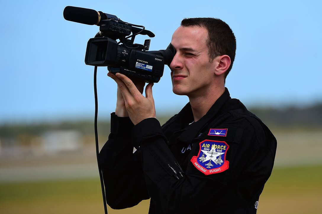 U.S. Air Force Staff Sgt. Tyler Vanwatermulen, F-22 Raptor Demonstration Team avionics specialist, films a demonstration during the Wings Over Golden Isles Air Show in Brunswick, Ga., March 24, 2017. Each show is filmed by a member of the team to provide after action feedback for the pilot and other team members. (U.S. Air Force photo/Senior Airman Kimberly Nagle)