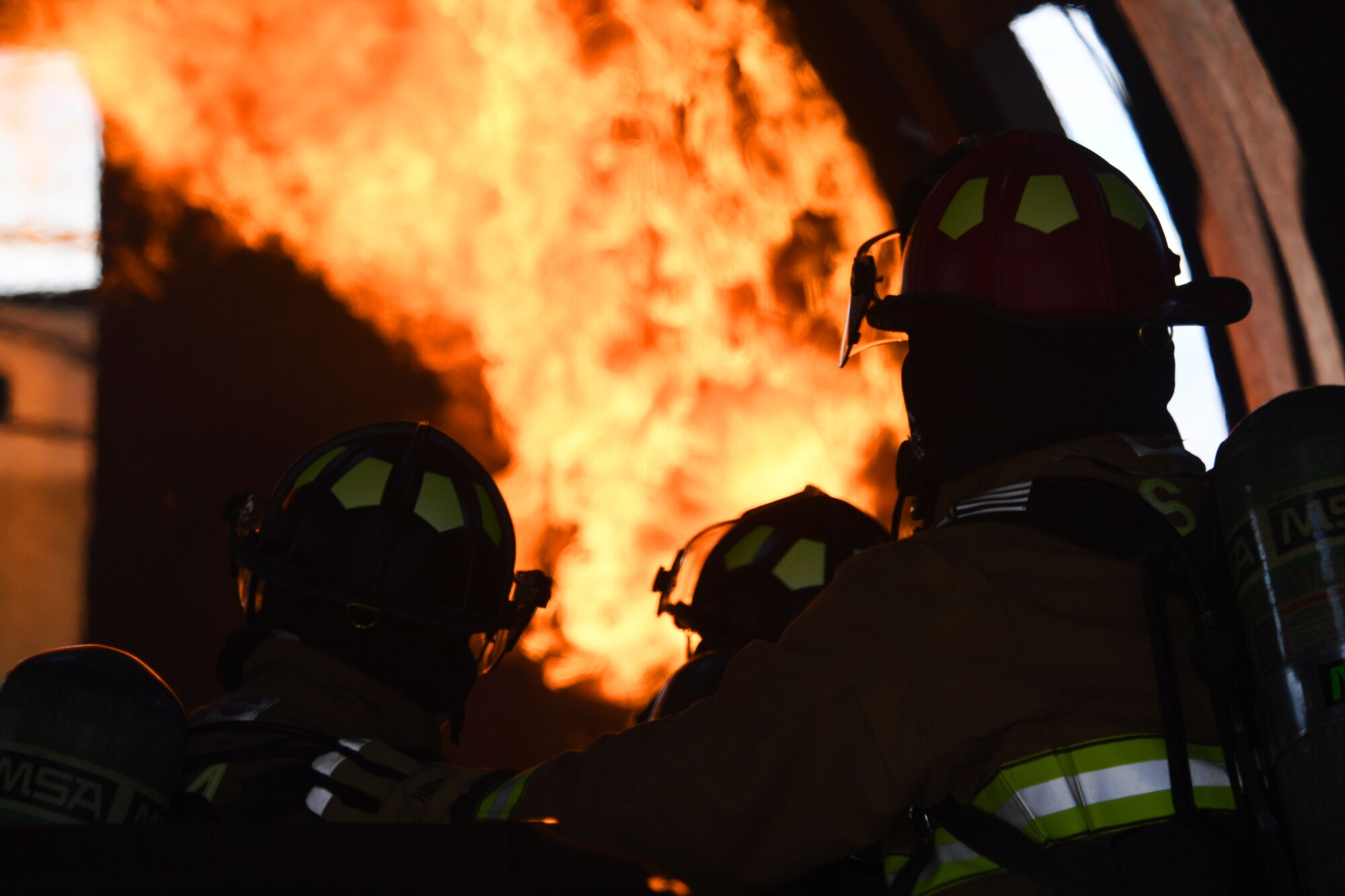 Airmen assigned to the 99th Civil Engineer Squadron Fire Protection Flight approach a controlled fire before extinguishing it March 23, 2017, at Nellis Air Force Base, Nev. Creech and Nellis firefighters completed one of the two required live fire training exercises to stay current with annual training. (U.S. Air Force photo/Airman 1st Class James Thompson) 