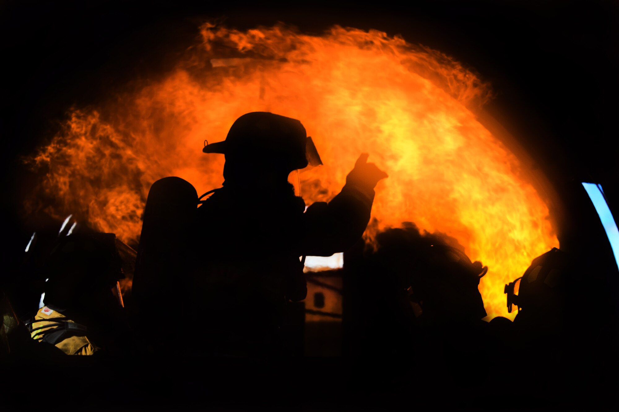 A team of Creech Airmen assigned to the 99th Civil Engineer Squadron Fire Protection Flight moves toward a controlled fire during an aircraft live fire training exercise March 23, 2017, at Nellis Air Force Base, Nev. Members of the 99th CES FPF are required to complete two aircraft live fire training and two structural live fire training exercises annually. (U.S. Air Force photo/Airman 1st Class James Thompson) 