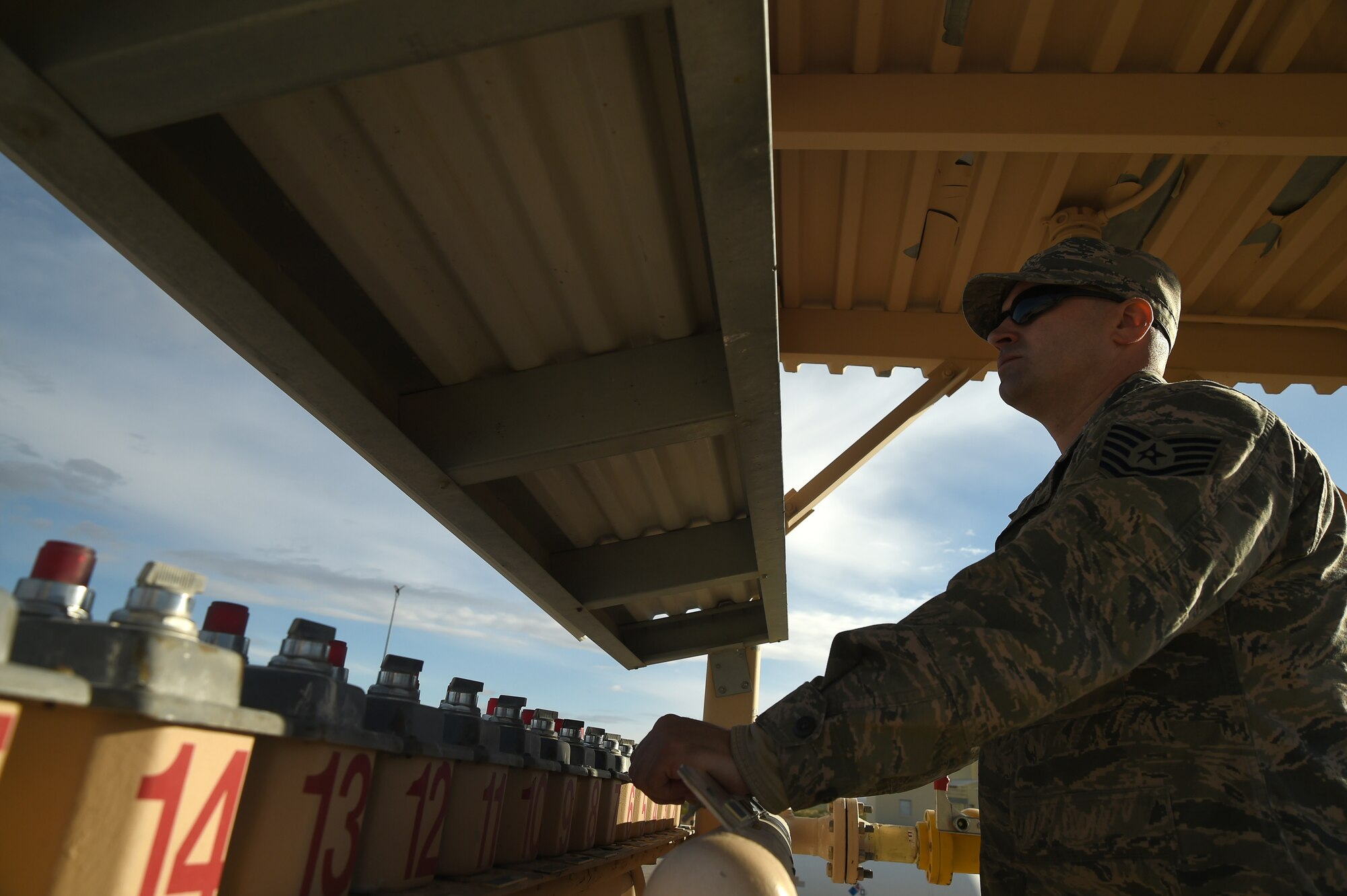 Tech. Sgt. John Muldoon, NCO in charge of training, operates the fuel and ignitor switches to control the fire sources during an aircraft live fire training exercise March 23, 2017, at Nellis Air Force Base, Nev. Muldoon communicated with the on-scene instructor to ensure the training objectives were met. (U.S. Air Force photo/Airman 1st Class James Thompson) 