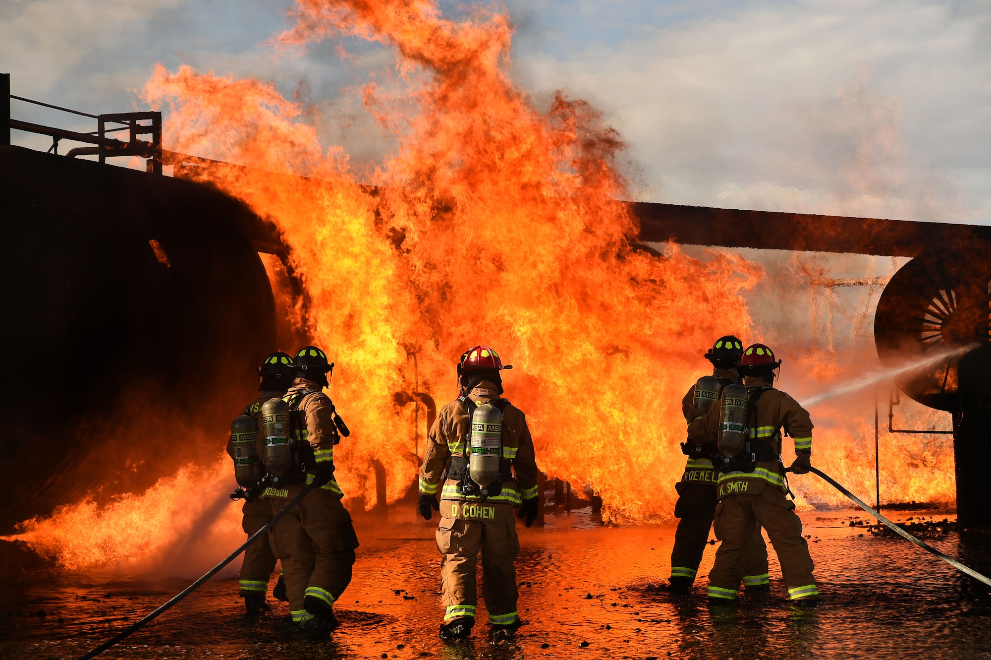Nellis and Creech Airmen assigned to the 99th Civil Engineer Squadron Fire Protection Flight extinguish a controlled fire on the exterior of a mockup aircraft March 23, 2017, at Nellis Air Force Base, Nev. The team extinguished both the exterior and interior of the aircraft and was evaluated on the team’s ability to work together to meet training objectives. (U.S. Air Force photo/Airman 1st Class James Thompson) 