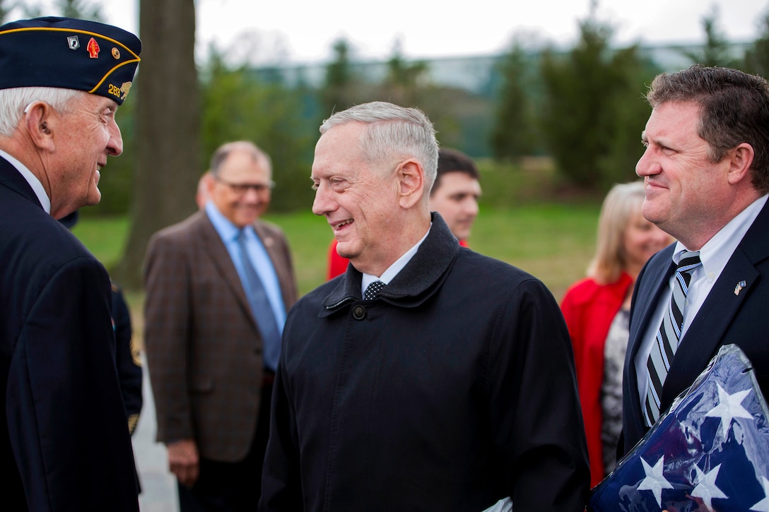 Defense Secretary Jim Mattis, center, and David Tincher, right, nephew of fallen Marine Corps Pvt. Harry K. Tye, talk with Kurt Heite, American Legion historian, during Tye's funeral service at Arlington National Cemetery in Arlington, Va., March 28, 2017. The Marine private was killed Nov. 20, 1943, during the Battle of Tarawa. History Flight recovered Tye's remains from Cemetery 27 on Tarawa, enabling him to be interned on U.S. soil. Marine Corps photo by Cpl. Dana Beesley