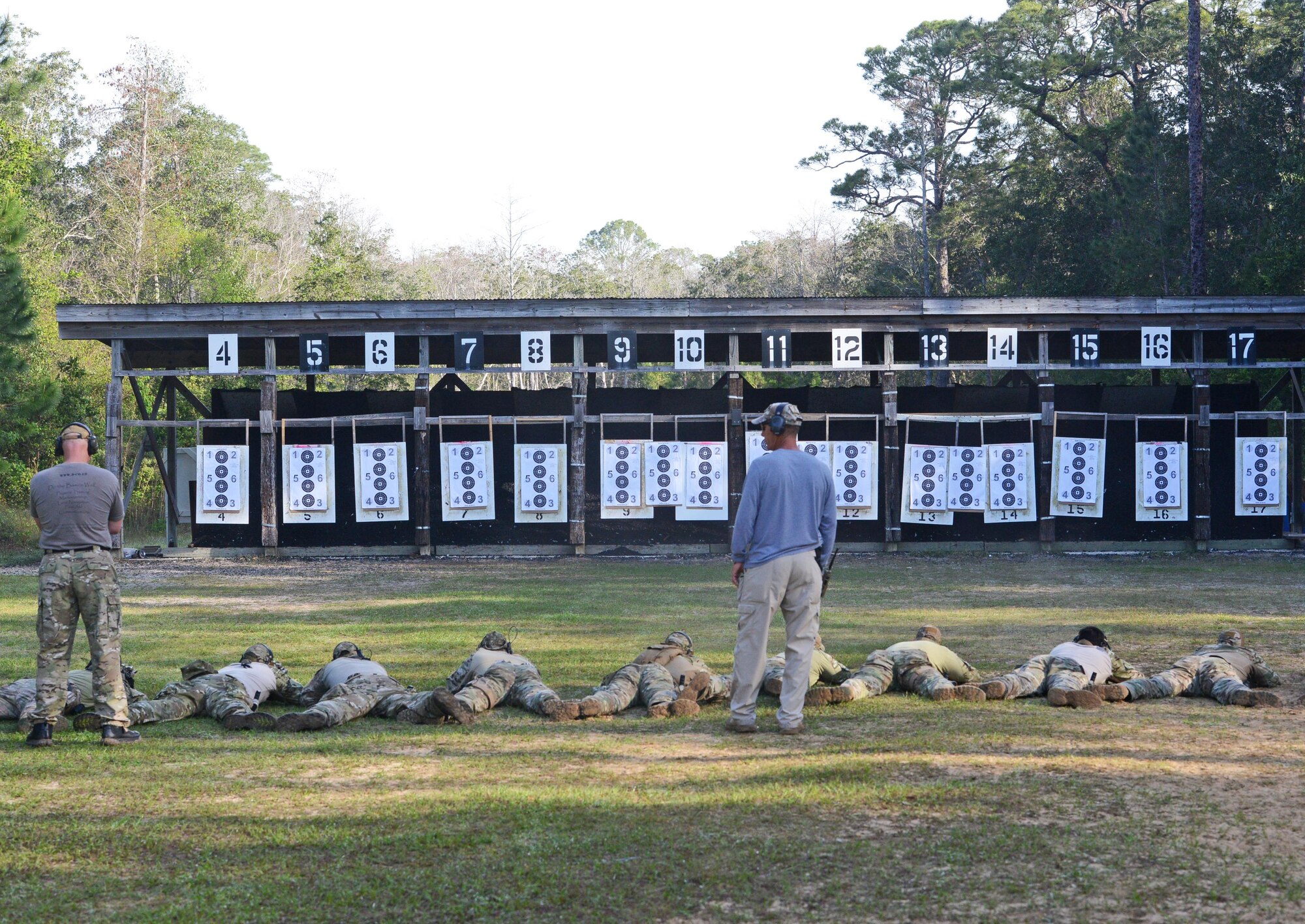 Special Tactics instructors observe newly assigned combat controllers at the Fire and Pistol Club on Hurlburt Field, Fla., March 29, 2017. Combat Controllers are trained special operations forces and certified air traffic controllers. Their mission is to deploy undetected into hostile combat and austere environments to establish assault zones or airfields. (U.S. Air Force photo/Staff Sgt. Melanie Holochwost)