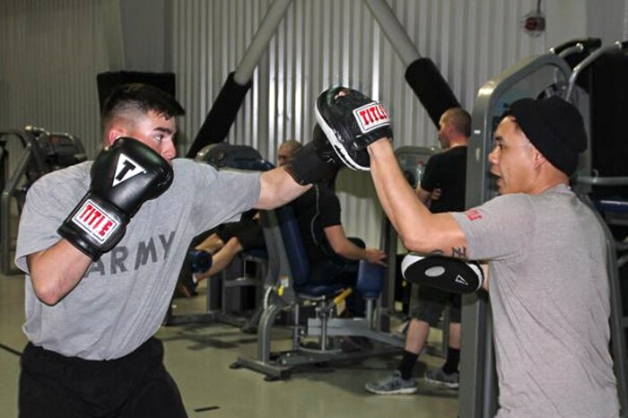Army Sgt. Marcos Benitez, left, an M1A2 Abrams tank gunner with 1st Battalion, 8th Infantry Regiment, spars with Sgt. 1st Class Joel Vallete, the battalion’s signal section chief, at a gymnasium at Mihail Kogalniceanu Air Base, Romania, March 8, 2017. Army photo by Spc. Matthew Searcy 