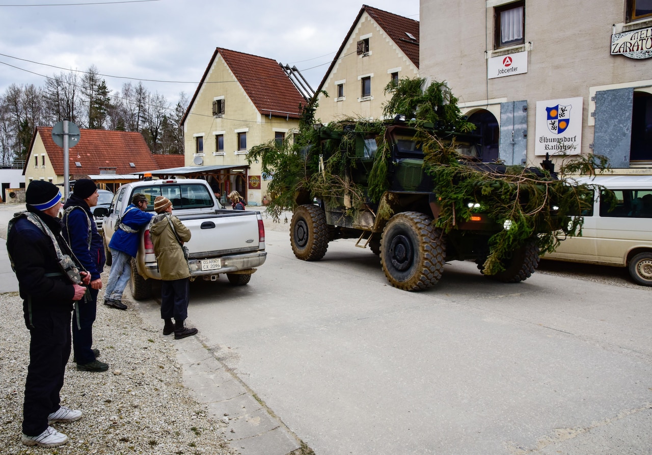 Civilian role players watch as Macedonian special operation forces patrol a simulated town at the Joint Multinational Readiness Center in Hohenfels, Germany, March 21, 2017. This operation was part of exercise Allied Spirit VI which integrates multinational special operation forces and conventional forces training towards combined interoperability and interdependence. Army photo by Sgt. Nelson Robles