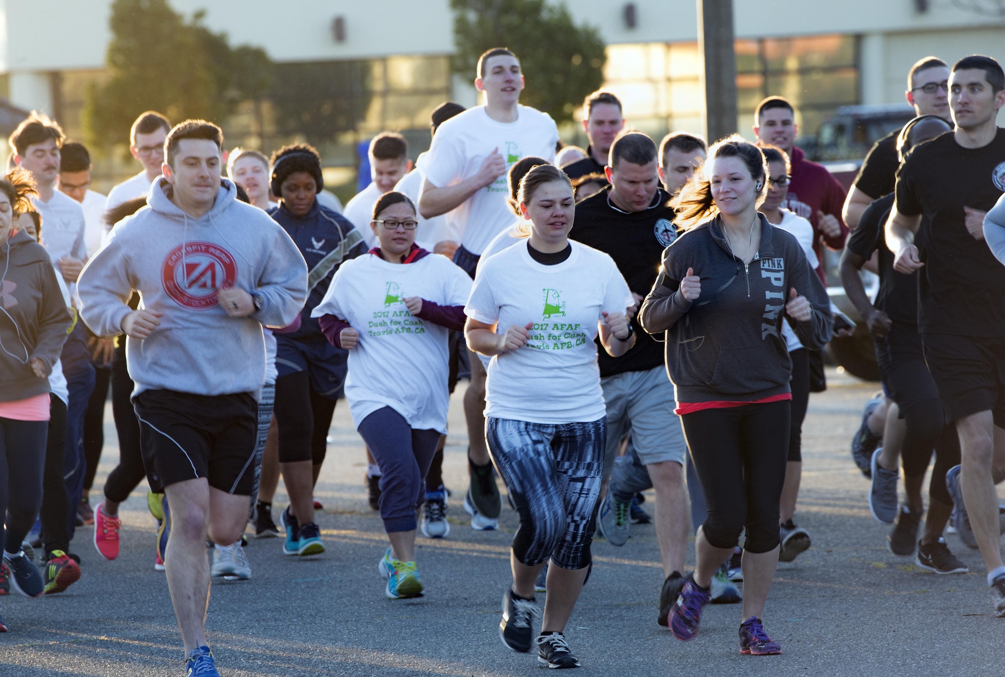 Racers begin the 2.5 mile fun run at the Air Force Assistance Fund (AFAF) kick off early Monday morning, Mar. 27, 2017, Travis Air Force Base, Calif. More than 200 people participated in the event which was held to raise awareness about the AFAF mission; supporting Air Force families in need, covering active duty, retirees, reservists, guard, dependents, and surviving spouses. (U.S. Air Force photo/ Heide Couch)