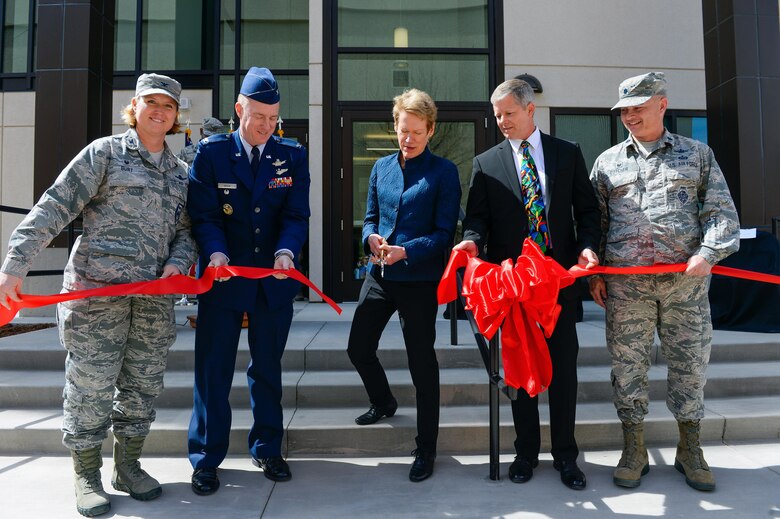 Col. DeAnna Burt, 50th Space Wing commander, Col. Matthew Skeen, National Reconnaissance Office Director of Space Launch, Betty Sapp, NRO Director, Gary Lund, NRO Management Services and Operations facility project manager, and Lt. Col. Bryan Dutcher, NRO Operations Squadron commander take part in a ribbon-cutting ceremony for the NOPS Annex March 21, 2017 at Schriever Air Force Base. More than 75 Airmen, civilians, military and community leaders witnessed the unveiling of the 19,985 square foot facility. (U.S. Air Force photo/Christopher DeWitt)