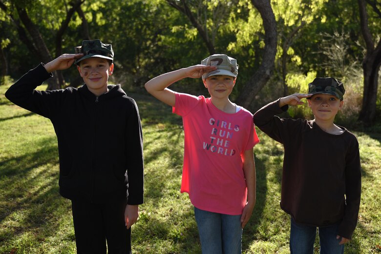 Military children celebrate their family heritage with their parent’s covers while playing at a park in San Angelo, Texas, March 29, 2017. Goodfellow Air Force base is celebrating Month of the Military Child in April by drawing attention to the sacrifice and support given from military children. (U.S. Air Force photo by Airman 1st Class Caelynn Ferguson/ Released)