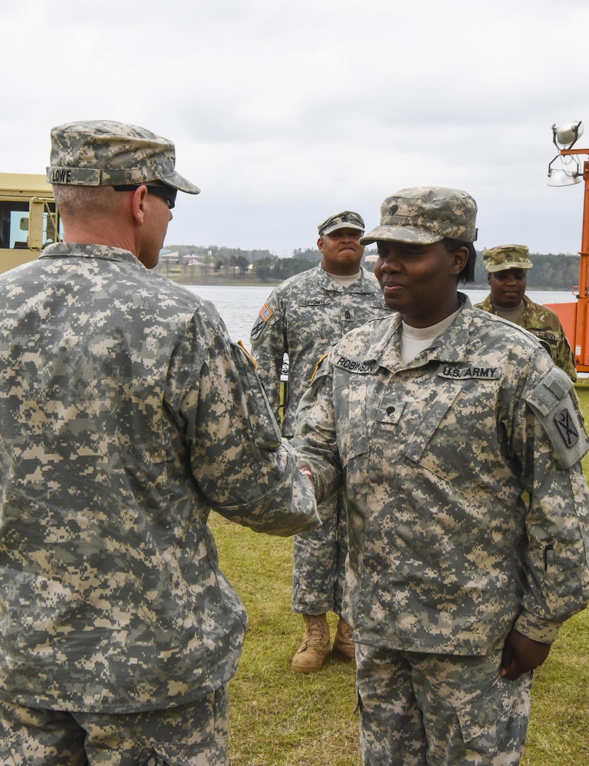 U.S. Army Spc. Courtney Robinson, Alpha Co., 218th BSB, South Carolina National Guard, is presented with a coin from Lt. Col. Robert Lowe, 348th BSB battalion commander, Georgia National Guard, for her hard work during Vigilant Guard 17 at the Amerson Water Treatment Plant in Macon, Georgia, March 28, 2017.