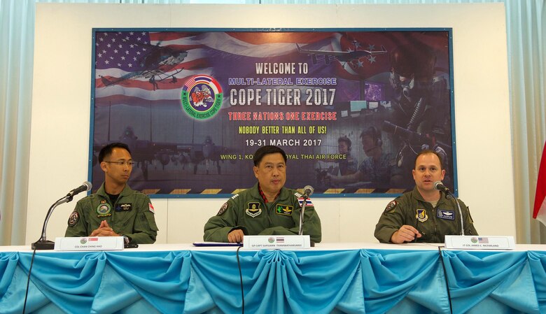 Republic of Singapore air force Col. Chan Ching Hao (left), Royal Thai air force Group Capt. Supijjarn Thamwatharsaree (center) and U.S. Air Force Lt. Col. James McFarland answer questions for media day during exercise Cope Tiger 17 at Korat Royal Thai Air Force Base, Thailand, March 28, 2017. The annual multilateral exercise, which involves a combined total of 76 aircraft and 43 air defense assets, is aimed at improving combined combat readiness and interoperability between the Republic of Singapore air force, Royal Thai air force, and U.S. Air Force, while concurrently enhancing the three nations' military relations. (U.S. Air Force photo by Staff Sgt. Kamaile Chan)