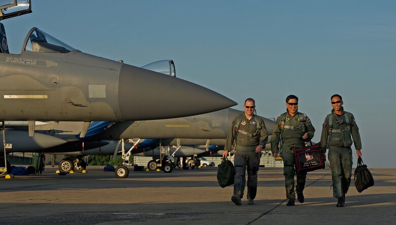 U.S. Air Force Lt. Col. James McFarland (left), Royal Thai air force Group Capt. Supijjarn Thamwatharsaree (center) and Republic of Singapore air force Col. Chan Ching Hao, exercise directors for exercise Cope Tiger 17 (CT17), walk past a row of U.S. Air Force F-15s during CT17 at Korat Royal Thai Air Force Base, Thailand, March 28, 2017. The annual multilateral exercise, which involves a combined total of 76 aircraft and 43 air defense assets, is aimed at improving combined combat readiness and interoperability between the Republic of Singapore air force, Royal Thai air force, and U.S. Air Force, while concurrently enhancing the three nations' military relations. (U.S. Air Force photo by Staff Sgt. Kamaile Chan)