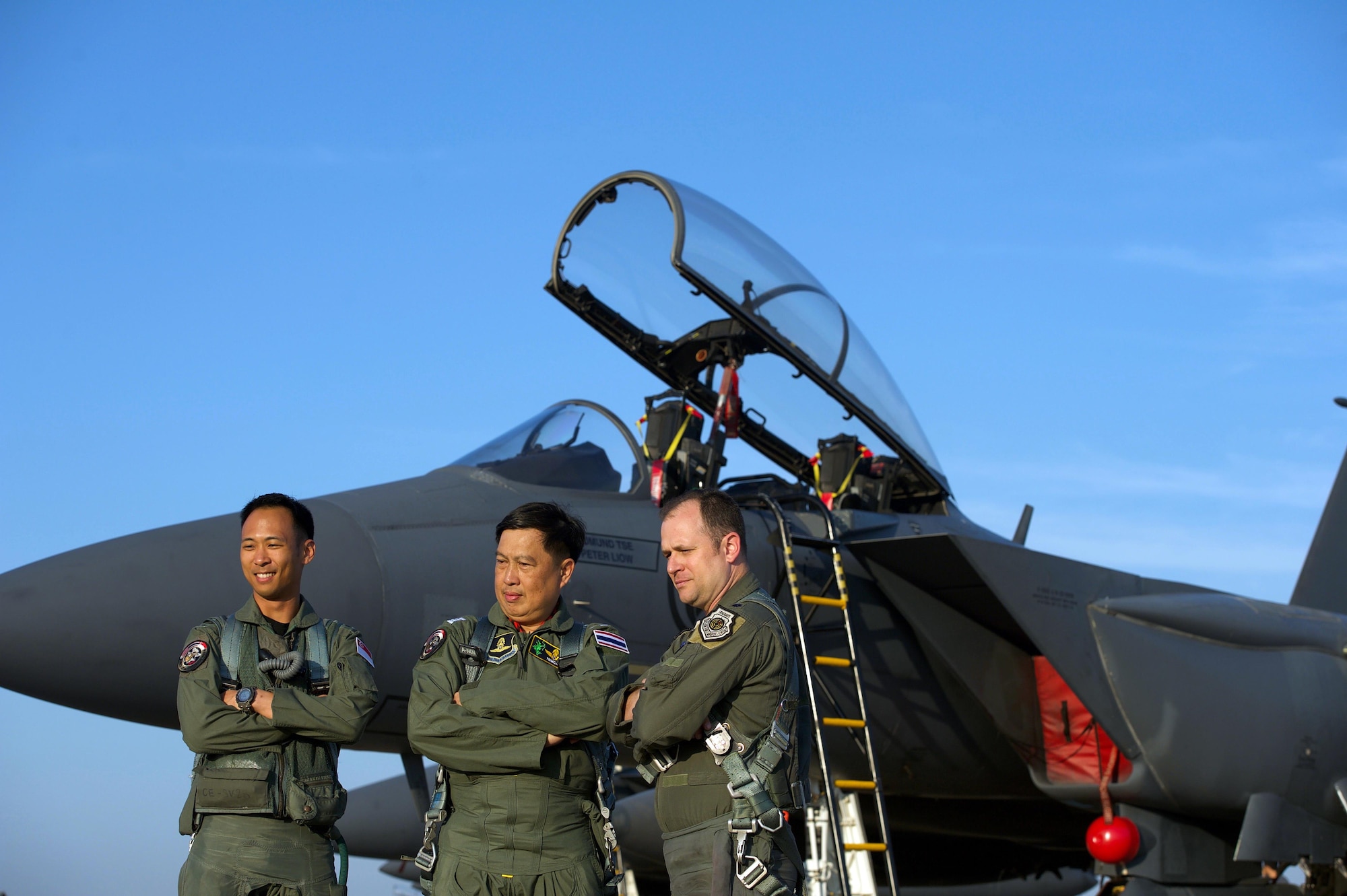 Republic of Singapore air force Col. Chan Ching Hao (left), Royal Thai air force Group Capt. Supijjarn Thamwatharsaree (center) and U.S. Air Force Lt. Col. James McFarland, exercise directors for Cope Tiger 17 (CT17) pose for a photo at Korat Royal Thai Air Force Base, Thailand, March 28, 2017. The annual multilateral exercise, which involves a combined total of 76 aircraft and 43 air defense assets, is aimed at improving combined combat readiness and interoperability between the Republic of Singapore air force, Royal Thai air force, and U.S. Air Force, while concurrently enhancing the three nations' military relations. (U.S. Air Force photo by Staff Sgt. Kamaile Chan)