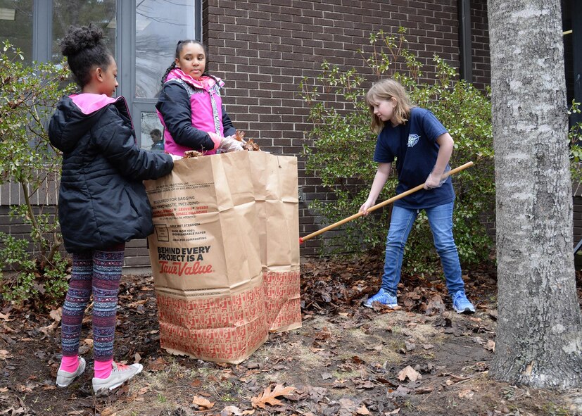Kayla Gervais, left, Brooke Osborne, center, and Chloe Sperry rake leaves outside the Youth Center as part of a community service project March 29. Throughout the week the Youth Center celebrated National Boys & Girls Club Week by recognizing the invaluable service they bring to the Hanscom community. (U.S. Air Force photo by Linda LaBonte Britt)