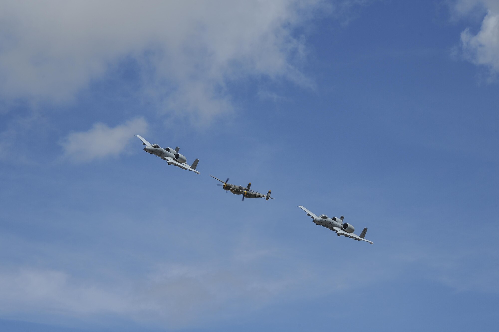 Two U.S. Air Force A-10C Thunderbolt IIs, assigned to the 354th Fighter Squadron and a part of the A-10 West Heritage Flight Team, and a P-38 Lightning fly in formation during the Los Angeles County Air Show in Lancaster, Calif., March 25, 2017. This is the team’s first air show performance after nearly five years of disbandment. (U.S. Air Force photo by Airman 1st Class Mya M. Crosby)