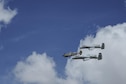Two U.S. Air Force A-10C Thunderbolt IIs, assigned to the 354th Fighter Squadron and a part of the A-10 West Heritage Flight Team, and a P-38 Lightning fly in formation during the Los Angeles County Air Show in Lancaster, Calif., March 25, 2017. This is the team’s first air show performance after nearly five years of disbandment. (U.S. Air Force photo by Airman 1st Class Mya M. Crosby)