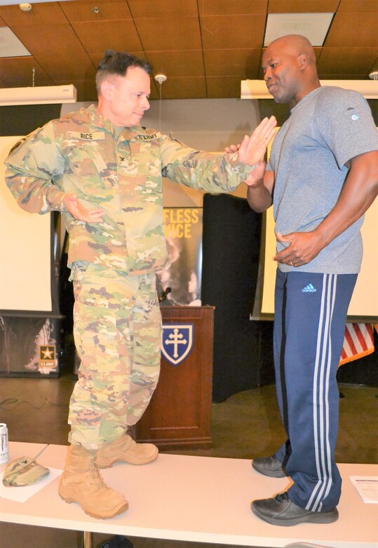Garba “Mister G” Onadja, who teaches people the benefits of a nutritious, healthy, fit lifestyle, demonstrates to Col. Vince Rice, 653rd Regional Support Group commander, martial arts moves, during a command-wide readiness session at the Los Alamitos Joint Forces Training Base, March 4. To kick off “The Year of Fitness,” Brig. Gen. David E. Elwell, 311th Expeditionary Sustainment Command commanding general, invited Tony Horton, a world-class motivational speaker and an author of top-selling books, and Garba “Mister G” Onadja, who teaches people the benefits of a nutritious, healthy, fit lifestyle, to give a motivational presentation.