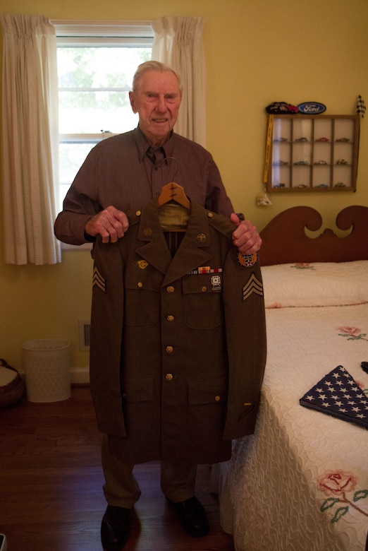William Dellinger, a 96-year-old veteran and native of Charlotte North Carolina reminisces on events during WWII, things he’s seen and the life he has lead, at his home Wednesday, Nov 2. Dellinger poses with his dress uniform. (U.S. Army Photo by Spc. Tynisha Daniel, 108th Training Command)