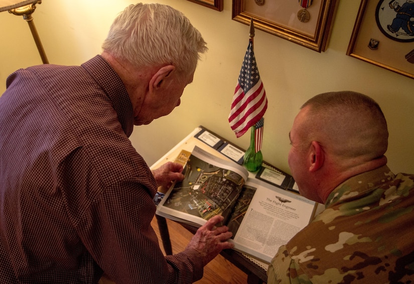 William Dellinger, a 96-year-old veteran and native of Charlotte North Carolina. reminisces on events with SFC. Brian Hamilton during WWII, things he’s seen and the life he has lead, at his home Wednesday, Nov 2. Dellinger logged every mission pursued during his WWII deployment and shares with Soldier the photo of the inside of a B29, the air craft he managed during his service. (U.S. Army Photo by Spc. Tynisha Daniel, 108th Training Command)