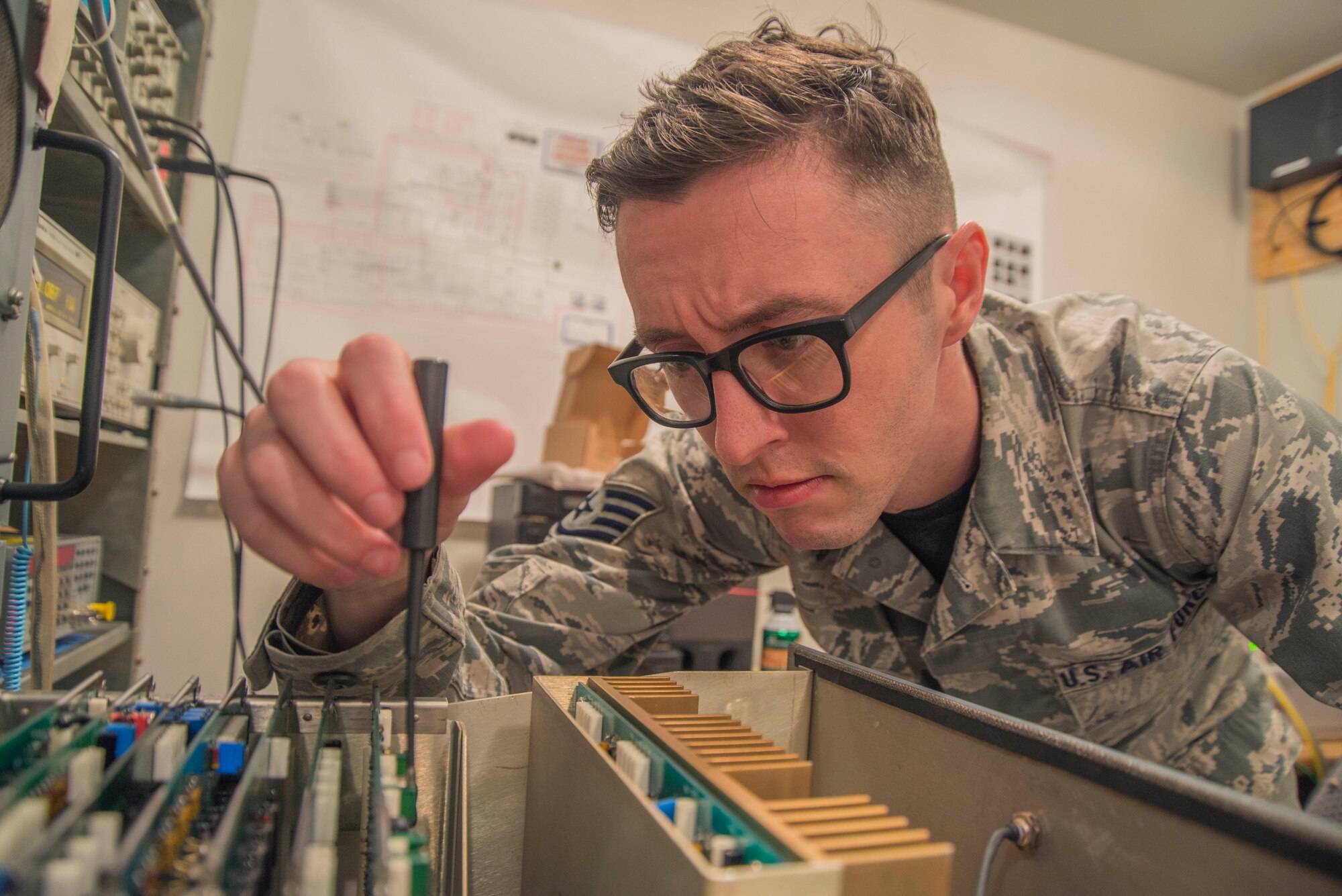 Staff Sgt. Roger Linder, 375th Operational Support Squadron airfield systems supervisor, aligns a tactical air navigation monitor. Doing this ensures the TACAN transponder is transmitting the correct azimuth, identification and distance to aircraft within 200 nautical miles. (U.S. Air Force photo by Airman Daniel Garcia. 