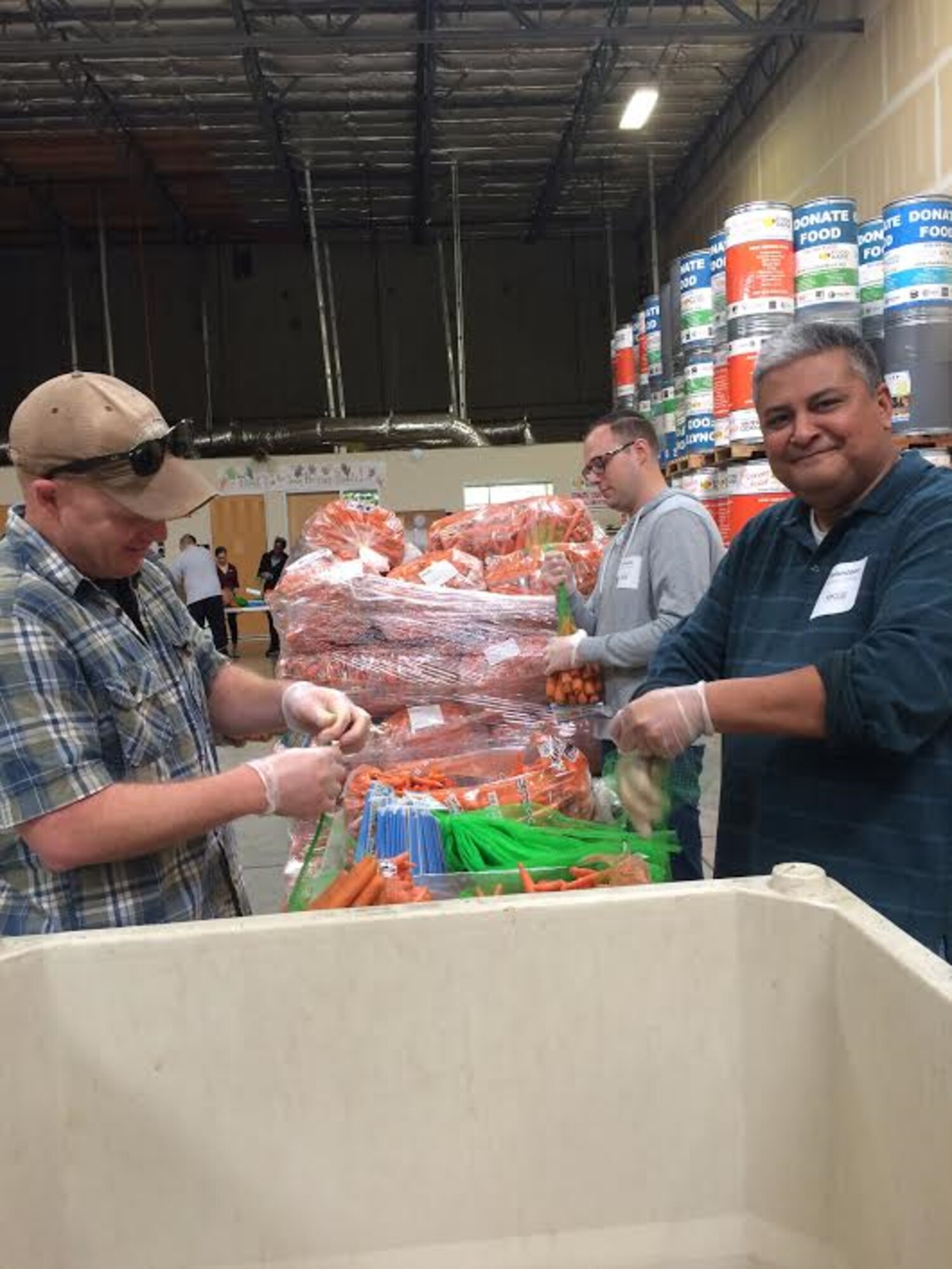 Airmen from the 60th Operations Group at Travis Air Force Base, Calif., help sort and package carrots during a volunteer event at the Solano Food Bank in Fairfield, Calif., March 24, 2017. More than 30 Airmen supported the event and packaged more than 6,700 pounds of food. (Courtesy Photo)