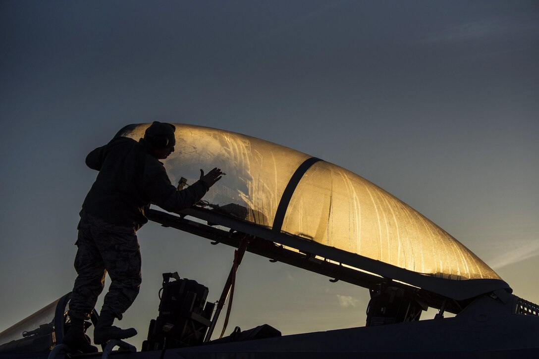 Air Force Staff Sgt. Joshua Matrine cleans the canopy on an F-15C Eagle aircraft from the Louisiana Air National Guard at Leeuwarden Air Base in the Netherlands, March 28, 2017. Members of the 122nd Expeditionary Fighter Squadron will train with NATO allies to strengthen interoperability and demonstrate U.S. commitment to the security and stability of Europe. Air Force photo by Staff Sgt. Jonathan Snyder