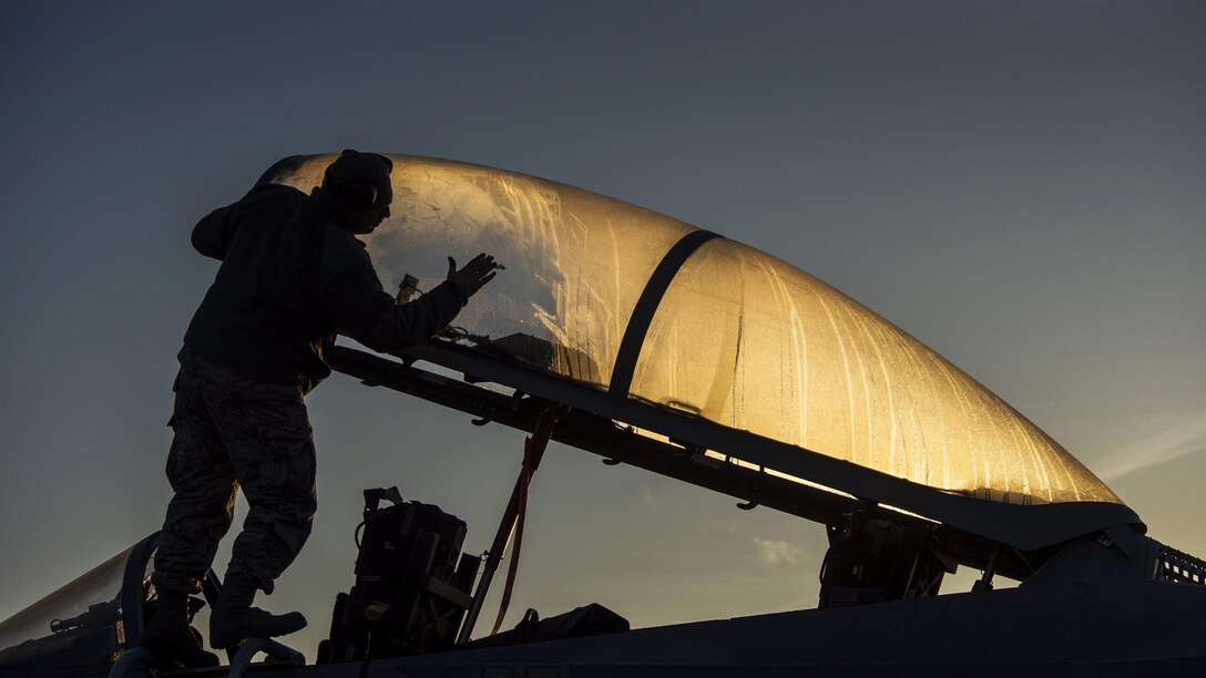 Air Force Staff Sgt. Joshua Matrine cleans the canopy on an F-15C Eagle from the Louisiana Air National Guard at Leeuwarden Air Base, Netherlands, March 28, 2017. Members of the 122nd Expeditionary Fighter Squadron will train with NATO allies to strengthen interoperability and demonstrate U.S. commitment to the security and stability of Europe. Air Force photo by Staff Sgt. Jonathan Snyder
