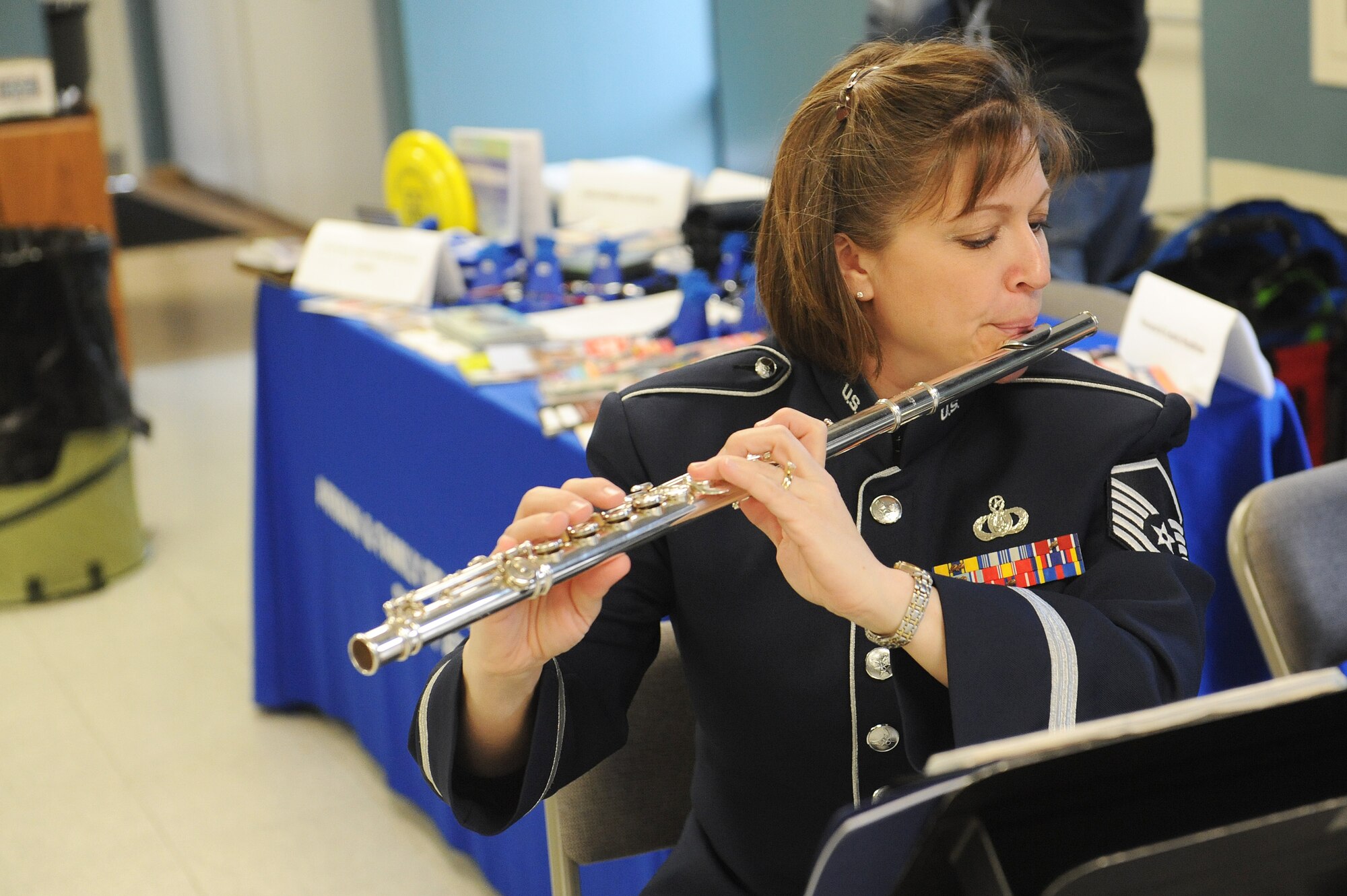 Master Sgt. Jennifer James, Band of Mid-America flutist, plays music during a women's resliency fair March 23 at Scott Air Force Base. The musicians provided entertainment for the duration of the two-hour event, playing a variety of songs, including the National Anthem and the Air Force Song. (U.S. Air Force photo by Tech. Sgt. Maria Castle)
