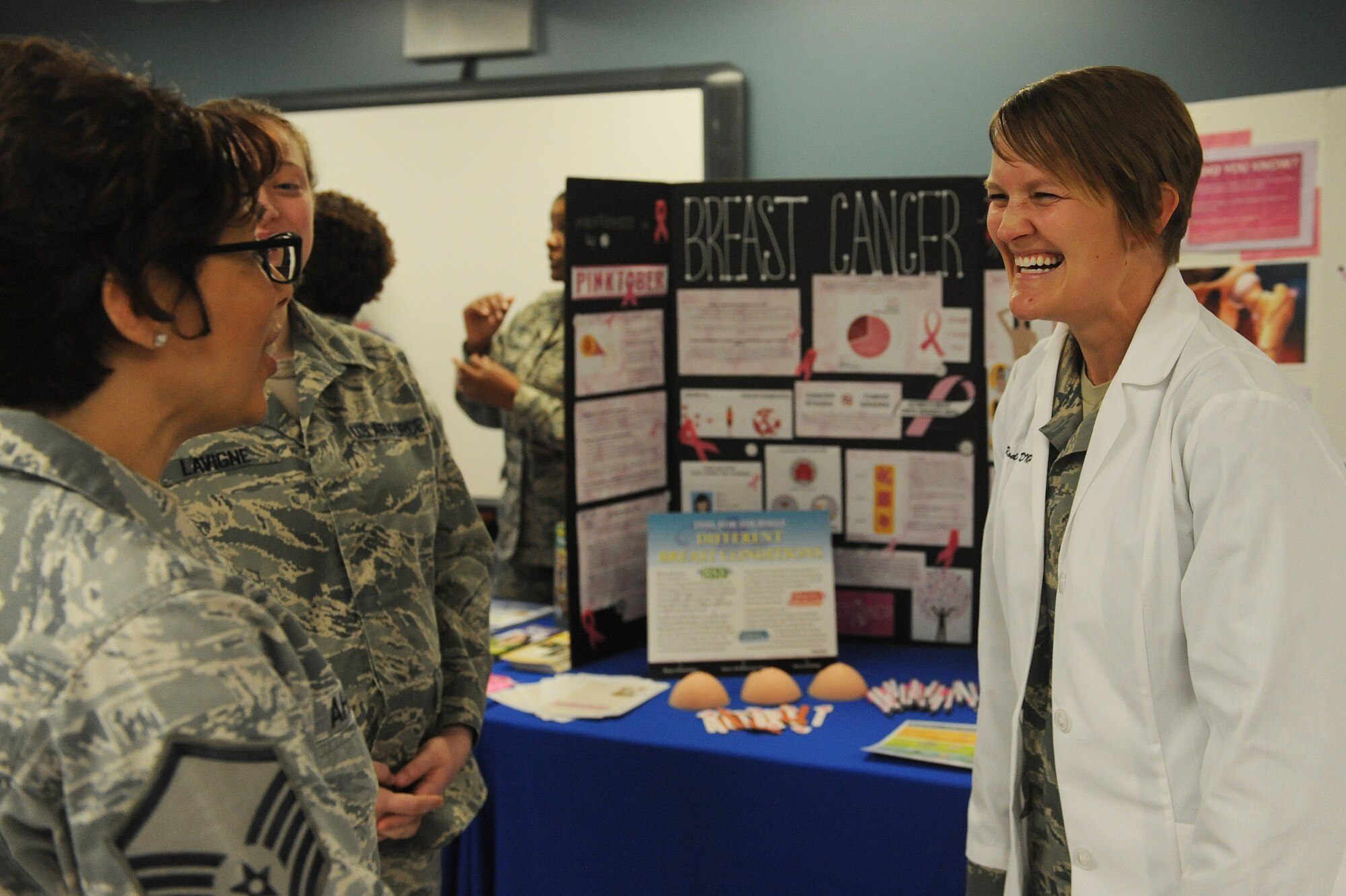 Maj. Lydia Rodriquez, 375th Medical Group Women's Health nurse, talks with guests about breast cancer screenings and birth control options during a women's resiliency fair March 23 at Scott Air Force Base.  Her display showed visitors how to check for lumps and provided visuals on different birth control methods and their effectiveness at preventing pregnancies. (U.S. Air Force photo by Tech. Sgt. Maria Castle)