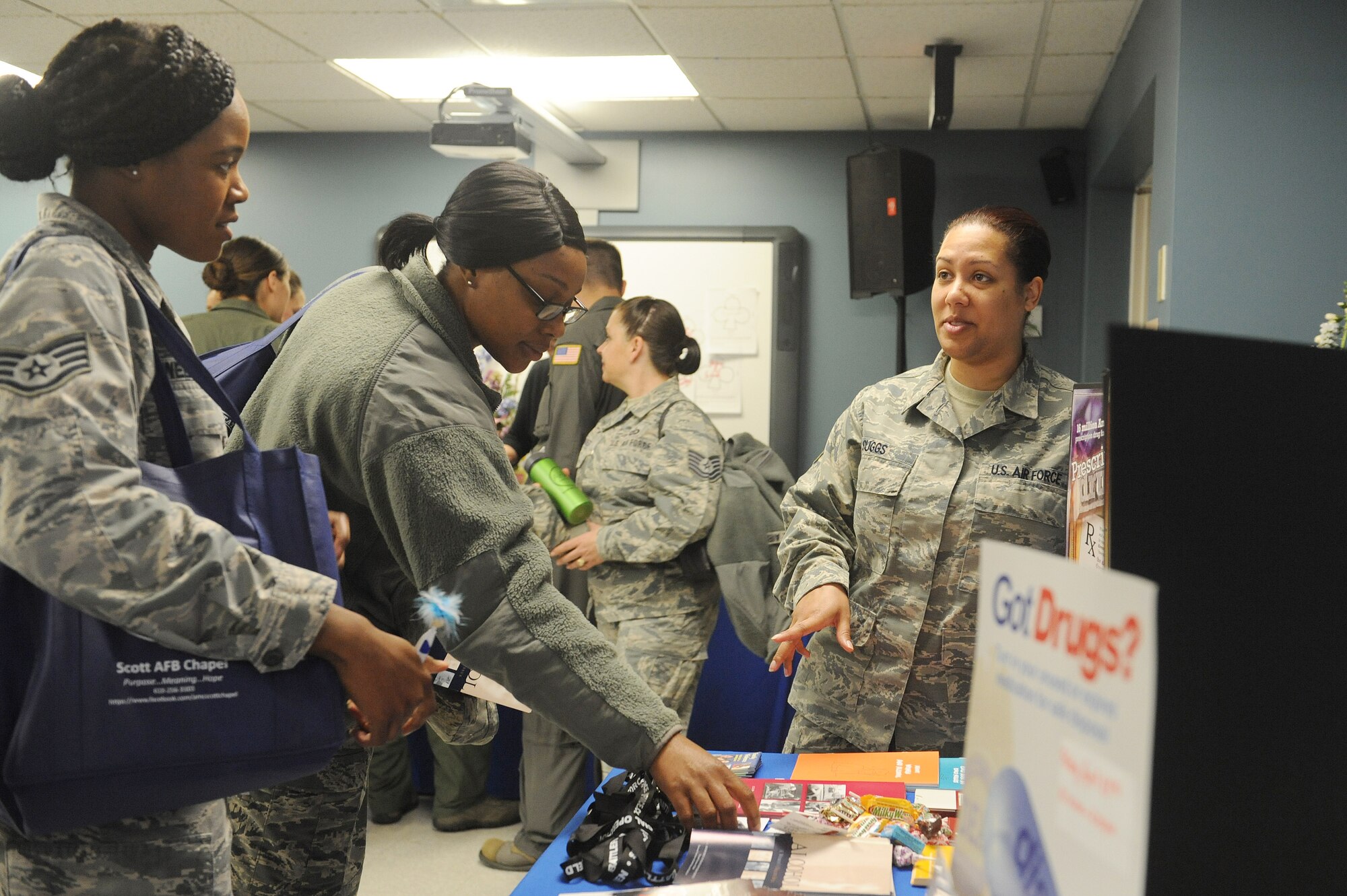 Staff Sgt. Markisha Suggs, 375th Medical Group Alcohol Drug Abuse Prevention and Treatment Clinic mental health technician, talks to Staff Sgt. Keisha Webster, 436th Supply Chain Operations Squadron NCO in charge of C-130 mission capable assets, and Tech. Sgt. Marquita Brown, 436th SCOS quick response flight NCO in charge, about drugs and how they can affect a them at a women's resiliency fair March 23 at Scott Air Force Base. The ADAPT Clinic works with patients dependant on drugs or alcohol and provides information about preventative measures. (U.S. Air Force photo by Tech. Sgt. Maria Castle)