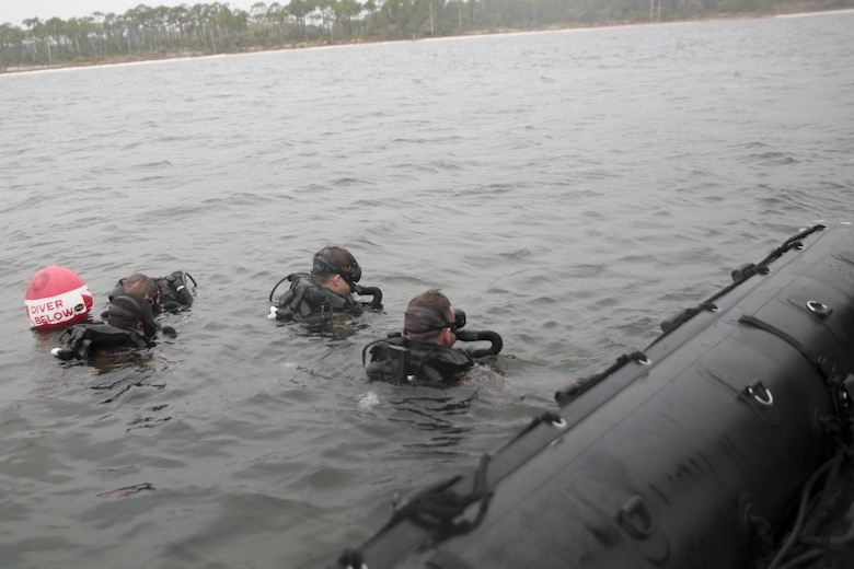 Marines with 3rd Force Reconnaissance Company enter the water during a ship-to-shore diving operation exercise at Pensacola, Fla., March 23, 2017. The exercise focused on performing sustainment training on Marine combative dive tactics. The training will enhance the company’s capability conduct specialized insertion and extraction tasks. (U.S. Marine Corps photo by Sgt. Ian Ferro)