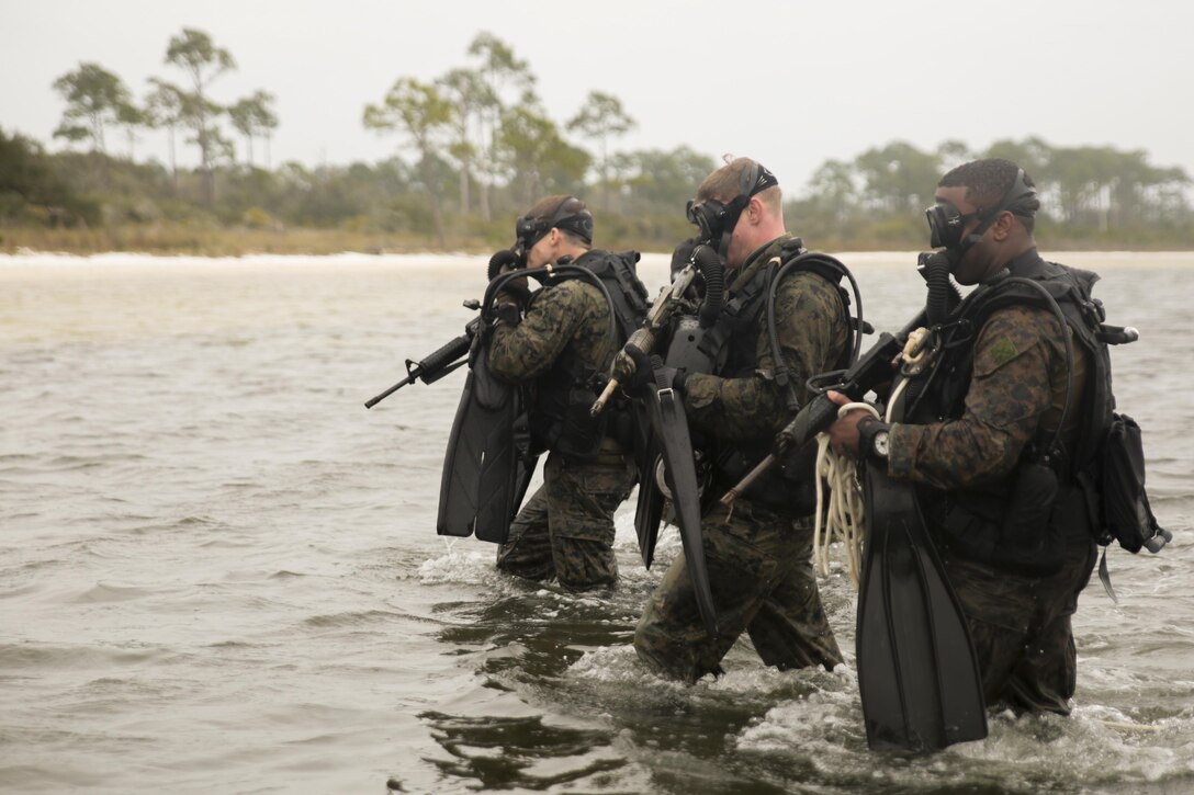 Staff Sgt. Daniel Franklin (left), team leader, Staff Sgt. Jamie Gill (center), team leader and Sgt. George Williams (right), assistant team leader with 3rd Force Reconnaissance Company, 4th Marine division exit the water during a ship-to-shore diving operation exercise at Pensacola, Fla., March 23, 2017. The exercise focused on performing sustainment training on Marine combative dive tactics. The training will enhance the company’s capability conduct specialized insertion and extraction tasks. (U.S. Marine Corps photo by Sgt. Ian Ferro)
