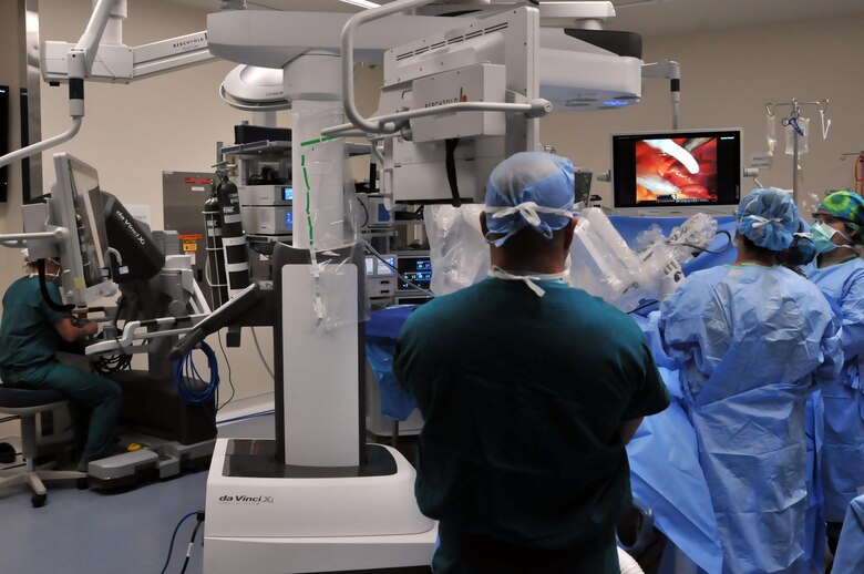 Members of the 81st Surgical Operations Squadron participate in the first robotic surgery in the Air Force, March 28, 2017, on Keesler Air Force Base, Miss. Using robotic surgery decreases risk of surgical sight infections while giving the surgeon better visibility and dexterity while operating, which improves the overall surgical procedure. (U.S. Air Force photo by Senior Airman Jenay Randolph)